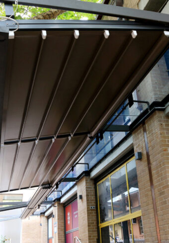 terra retractable pergola - pleated roof system in black