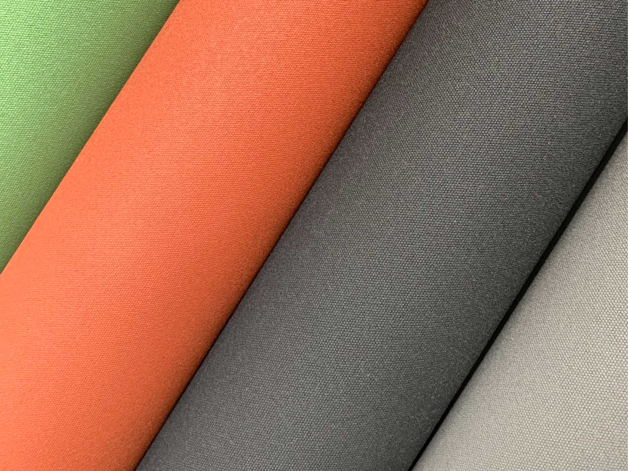 Outdoor awning fabric rolls in green, orange, charcoal and light grey for external roller blinds